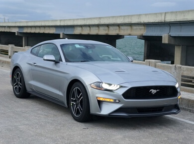 domestic vehicle service and repair in Escondido CA image of silver ford mustang parked near cement bridge over water