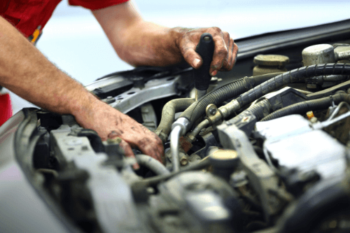 4 Signs You Need Expert Engine Repair and Maintenance in Escondido CA with John's Auto Pros; image of mechanics greasy hands performing engine maintenance
