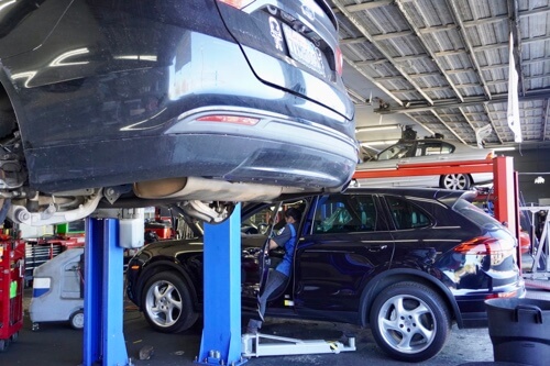 Foreign Vehicle repair in Escondido, CA with John's Auto Pros image of lexus suv being driven in shop bay area for services