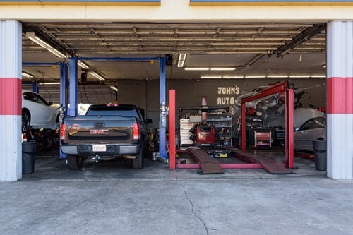 Protect your tires in Escondido, CA with John's Auto Pros, image of the alignment lifts in bay area of shop